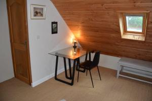 a table and chairs in a room with a staircase at Le clos de la lande vallée in Bringal +34 photos