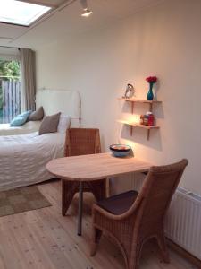 a room with a table and chairs and a bed at BBBoekelo appartement in Boekelo