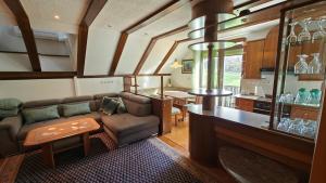 a living room with a couch and a table at Guesthouse Pri Zalogarju in Železniki