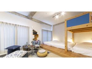 a bedroom with two bunk beds and a chair at Many Thanks Resort Onomichi - Vacation STAY 15793 in Onomichi