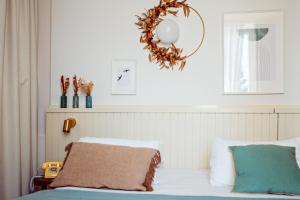 a bedroom with a bed with a wreath on the wall at Hôtel Maison Lacassagne Lyon in Lyon