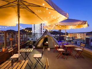 a patio with tables and chairs and a tent at Many Thanks Resort Onomichi - Vacation STAY 15793 in Onomichi