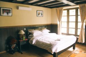 A bed or beds in a room at Mountain Lodges of Nepal - Monjo