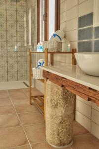 a bathroom with a counter with a sink at Casas Rurales El Aljibe, Jara in Argés