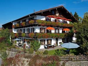 a large building with an umbrella in front of it at Zellnerhof in Gstadt am Chiemsee