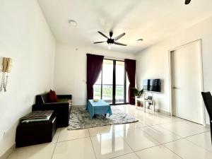 a living room with a couch and a ceiling fan at Entire Condominium @ Woodsburry Butterworth Penang in Butterworth