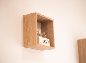 una caja de madera con un cartel de la casa en la pared en Grand Studio, en Le Blanc-Mesnil
