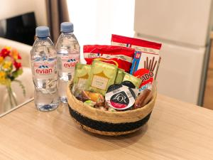 a basket of food and drinks on a table with water bottles at Grand Studio in Le Blanc-Mesnil