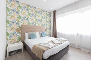 A bed or beds in a room at 247 Luxury Rooms Trastevere
