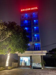 a building with blue lights on top of it at Amazon Hotel in Vinh