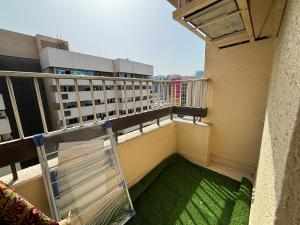 a balcony with a view of a building at Beautiful and Spacious Room, Rigga in Dubai