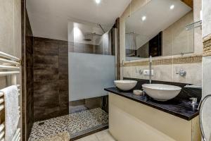 a bathroom with two sinks and a mirror at Chalet Serena - luxury 7 Bedroom Chalet, Pool & Spa in Les Houches