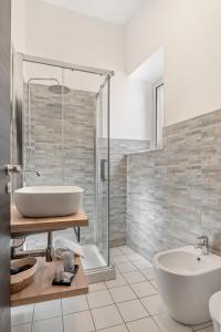 a bathroom with a tub and a sink and a shower at B&B Casa Giunchiglia in Noto