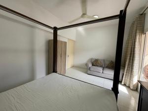 a bedroom with a bed and a couch in a room at Beautiful and Spacious Room, Rigga in Dubai
