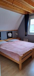 a bedroom with a large bed in a attic at Ferienhaus Rosenthal in Anjum +21 photos