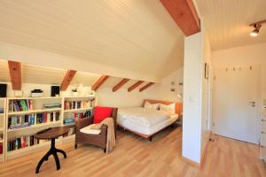 a bedroom with a bed and a book shelf at Ferienwohnungen Roseninsel & Perle in Feldafing