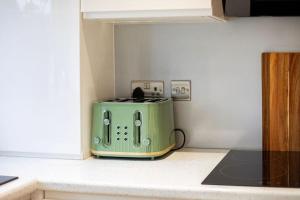 a green toaster sitting on top of a kitchen counter at “Hot Tub, Private Parking, Beachside Luxury” in Cleethorpes