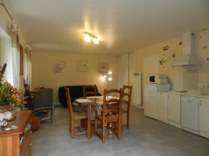 a kitchen and dining room with a table and chairs at HERMITAGE DURAS in Anzex