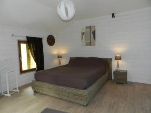 a bedroom with a large bed and a window at HERMITAGE DURAS in Anzex
