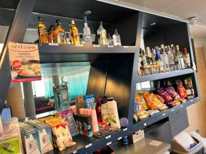 a shelf filled with lots of bottles of alcohol at Elis Boutique Hotel in Bat Yam