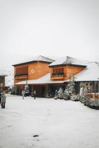 a large building with snow on the roof at The Mountains Hotel in Sierra Nevada