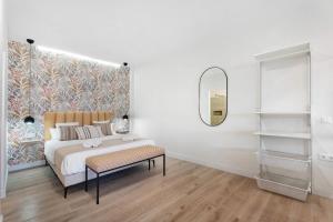 a white bedroom with a bed and a mirror at Loft The Pa By Paramount Holidays in Adeje