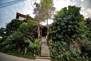 a house with stairs leading up to it at Homestay Long Coc in Phú Thọ