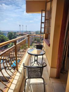 a balcony with a table and chairs and a view at Sleek Apartment with City Views in Nairobi