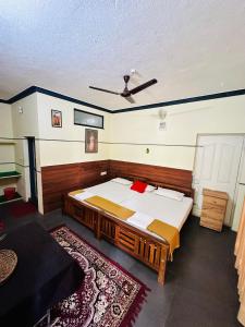 a bedroom with a large bed with a ceiling at Thoppil Homestay Munnar in Munnar