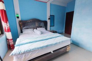 Voodi või voodid majutusasutuse AS Resto,Café & Hotel Mitra RedDoorz toas