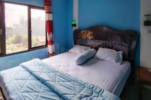 Voodi või voodid majutusasutuse AS Resto,Café & Hotel Mitra RedDoorz toas