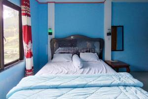 Voodi või voodid majutusasutuse AS Resto,Café & Hotel Mitra RedDoorz toas
