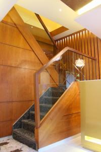 a spiral staircase in a building with wooden walls at MAROL METRO HOTEL MUMBAI in Mumbai