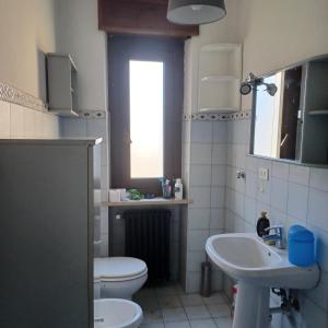a bathroom with a toilet and a sink at Alloggio Grande Joséphine in Oulx