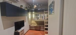 a living room with a couch and a tv at Le Perchoir de Cassis Cocoon in Cassis