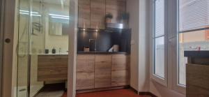 a bathroom with a sink and a glass shower at Le Perchoir de Cassis Cocoon in Cassis