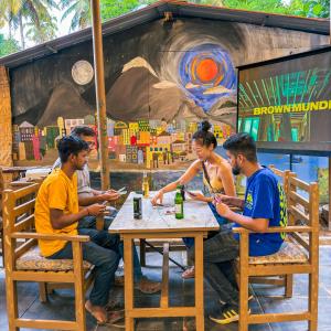 a group of people sitting at a table at Traverse Luxe Hostel Palolem in Palolem