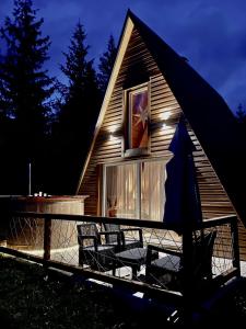 a house with a deck with chairs and a window at WoodMood in Žabljak