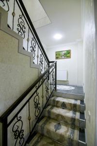 a staircase in a home with a stair case at Cozy Two-Storey House in Bukhara