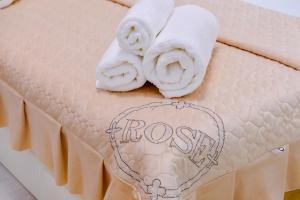 a close up of a mattress with towels on it at Cozy Two-Storey House in Bukhara