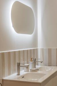 a bathroom with a sink and a mirror at Malvarrosa Beach Stay! in Valencia