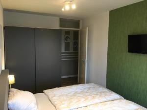 a bedroom with a bed and a flat screen tv at Amelander Paradijs Ferienwohnung in Buren