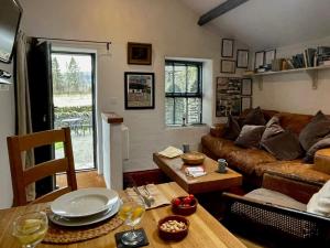 a living room with a couch and a table at 1 Bed in Ullswater 94066 in Watermillock