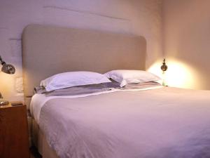 a bedroom with a white bed with two pillows at 1 Bed in Ullswater 94066 in Watermillock