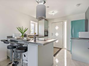 a kitchen with a counter and stools in a room at 1 Bed in Crackington Haven 93958 in Jacobstow