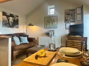 a living room with a couch and a table at 1 Bed in Ullswater 94069 in Watermillock