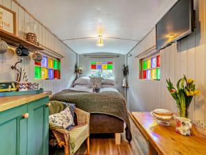 a bedroom with a bed in a room with stained glass windows at 1 Bed in Hartington 93565 in Hartington