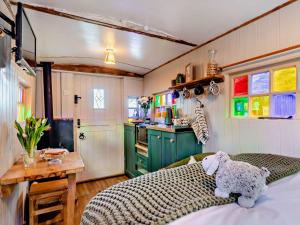a room with a bed with a teddy bear on it at 1 Bed in Hartington 93565 in Hartington