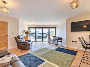 a living room with a couch and a tv and a table at 1 Bed in Woolacombe 93920 in Woolacombe