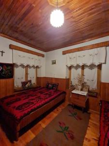 a bedroom with a large bed and a wooden ceiling at Το παραδοσιακό in Kalabaka